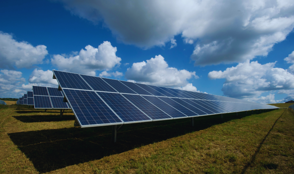 High-efficiency industrial rooftop commercial solar installation on a large metal warehouse.