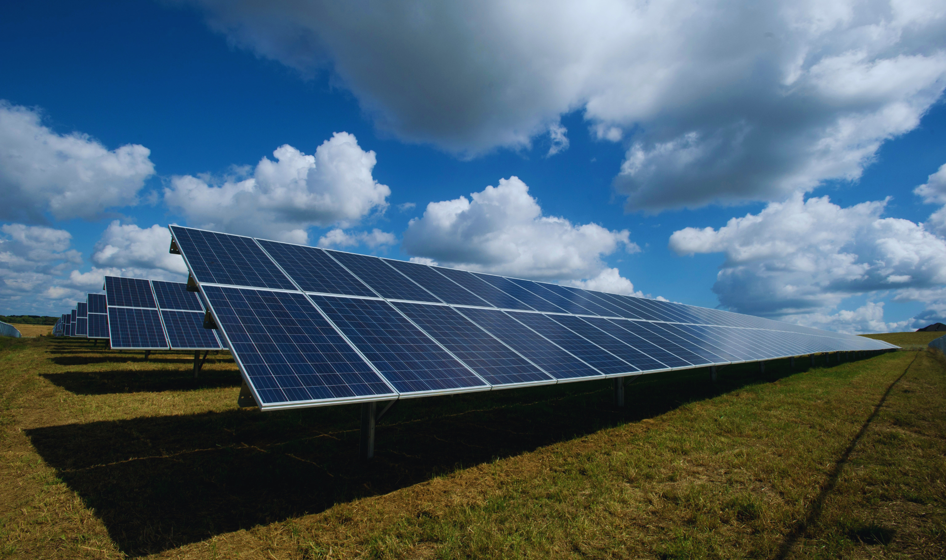High-efficiency industrial rooftop commercial solar installation on a large metal warehouse.