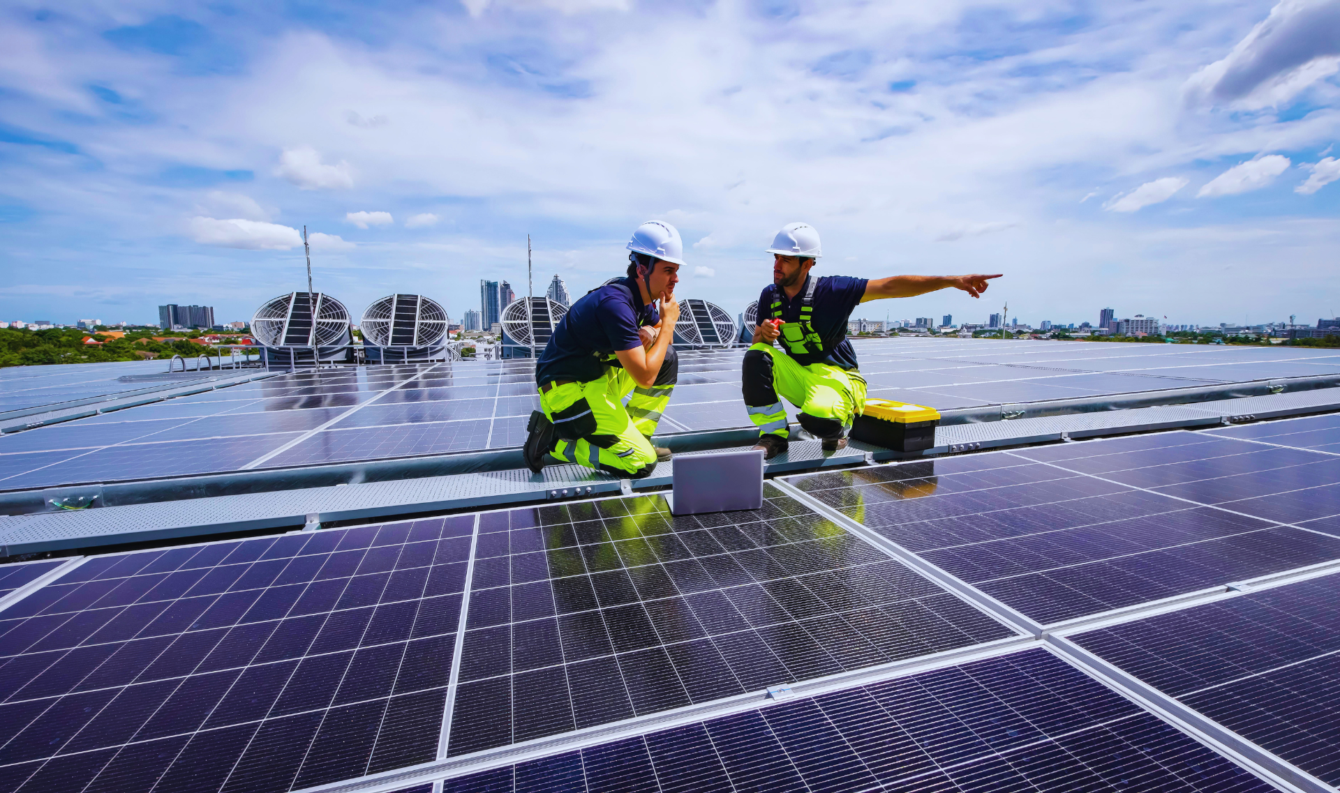 Sleek black monocrystalline solar panels installed on a tilted shingle roof under a blue sky.
